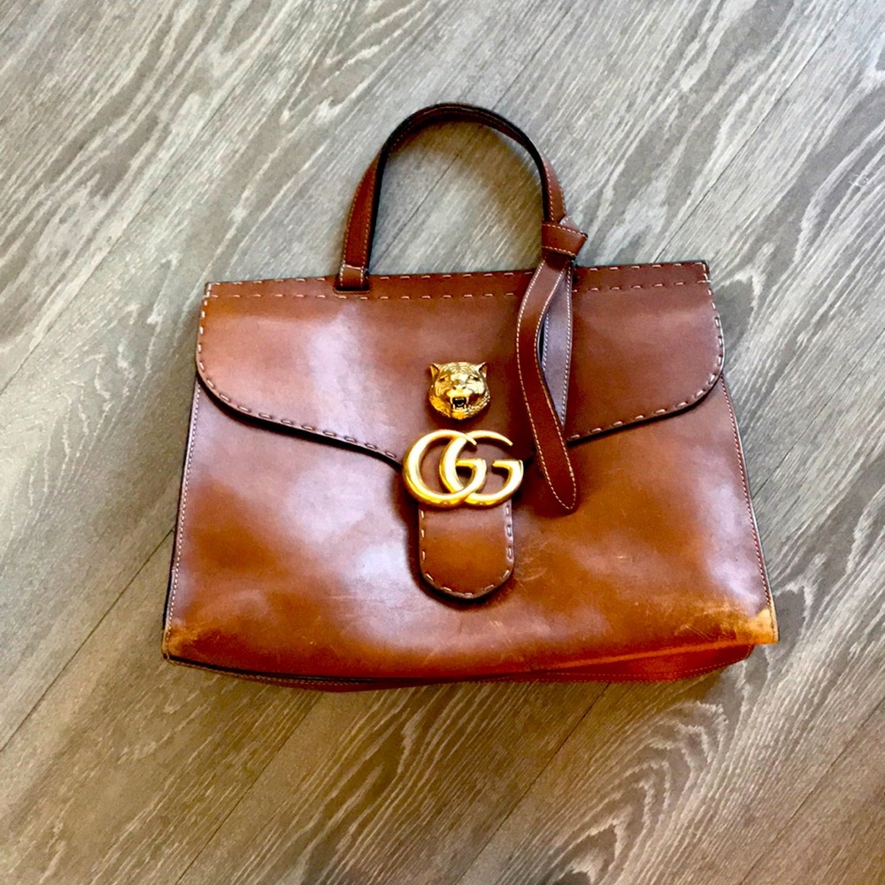 Rich cognac satchel by Gucci.  Stylish, real and large enough to hold big items!